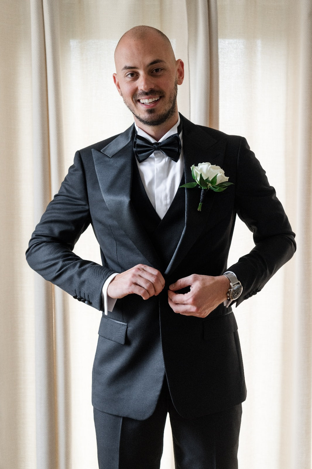 Man Groom in black formal tuxedo and bow tie for wedding